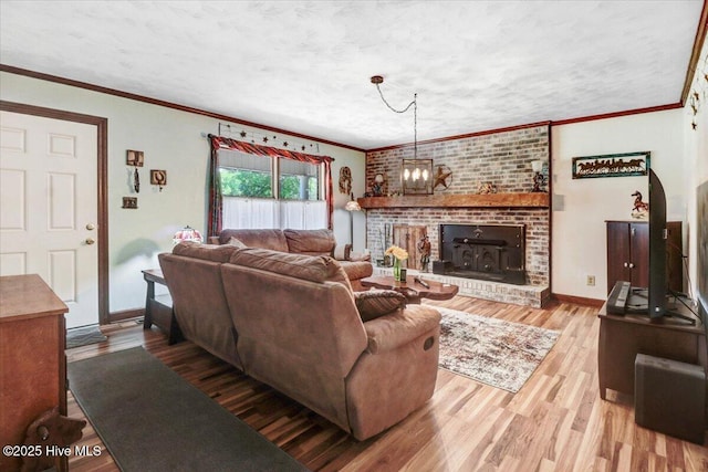 720 Swains Mill Rd, Harrellsville, NC 27942 - living area featuring wood finished floors, baseboards, a brick fireplace, ornamental molding, and a chandelier