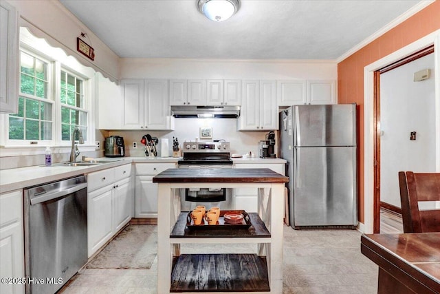 720 Swains Mill Rd, Harrellsville, NC 27942 - kitchen with stainless steel appliances, under cabinet range hood, a sink, white cabinetry, and ornamental molding