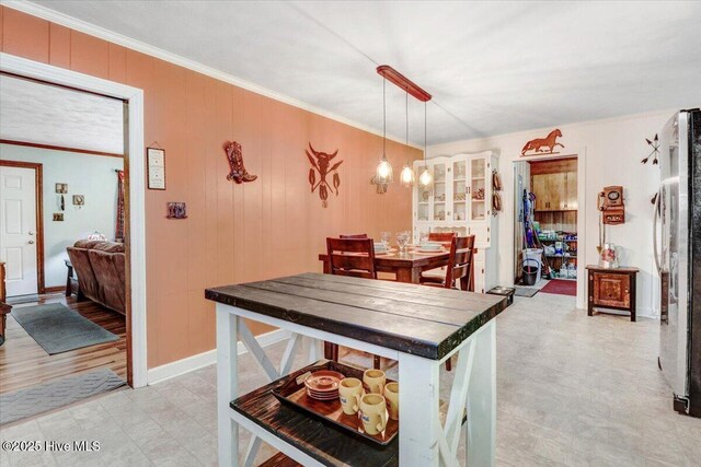 720 Swains Mill Rd, Harrellsville, NC 27942 - dining room featuring ornamental molding, a chandelier, wooden walls, and light floors