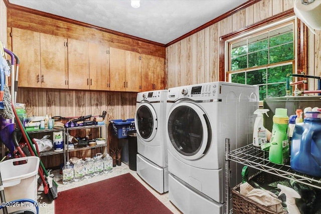 720 Swains Mill Rd, Harrellsville, NC 27942 - washroom with ornamental molding, separate washer and dryer, wood walls, and cabinet space