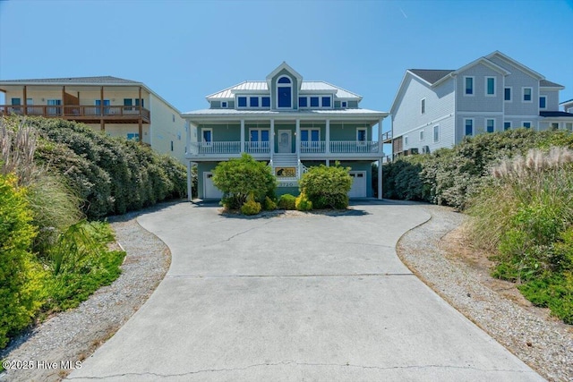 3720 Island Dr, North Topsail Beach, NC 28460 - coastal home with a garage, metal roof, a standing seam roof, and concrete driveway