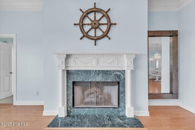 3720 Island Dr, North Topsail Beach, NC 28460 - details featuring baseboards, a high end fireplace, wood finished floors, and a notable chandelier