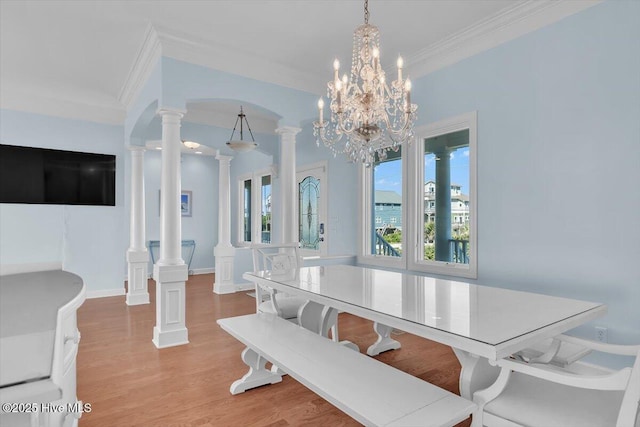 3720 Island Dr, North Topsail Beach, NC 28460 - dining room with ornamental molding, ornate columns, wood finished floors, and a notable chandelier