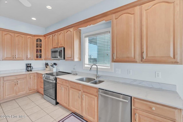 3720 Island Dr, North Topsail Beach, NC 28460 - kitchen featuring light brown cabinetry, a sink, light tile patterned floors, glass insert cabinets, and stainless steel appliances