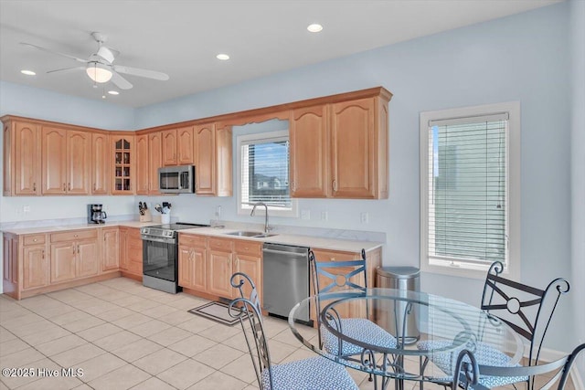 3720 Island Dr, North Topsail Beach, NC 28460 - kitchen with glass insert cabinets, ceiling fan, light countertops, a sink, and appliances with stainless steel finishes