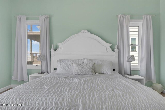 3720 Island Dr, North Topsail Beach, NC 28460 - bedroom with baseboards and multiple windows