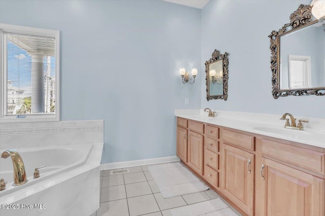 3720 Island Dr, North Topsail Beach, NC 28460 - bathroom featuring tile patterned flooring, double vanity, baseboards, a bath, and a sink
