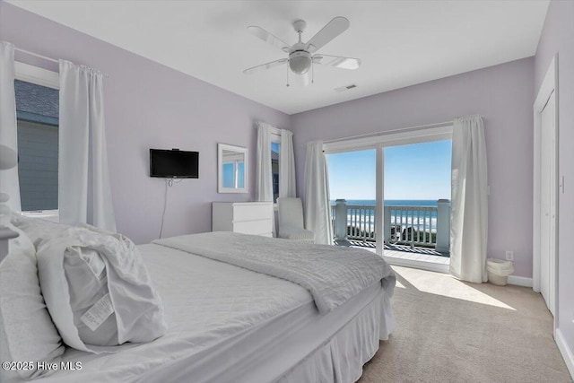 3720 Island Dr, North Topsail Beach, NC 28460 - bedroom featuring visible vents, access to exterior, baseboards, ceiling fan, and light colored carpet