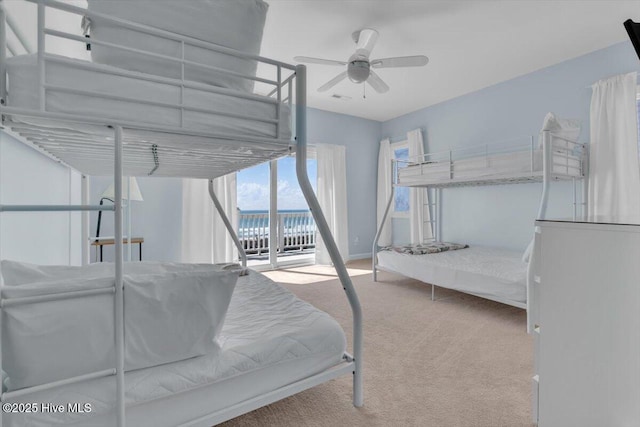 3720 Island Dr, North Topsail Beach, NC 28460 - bedroom with ceiling fan, access to exterior, carpet, baseboards, and a water view
