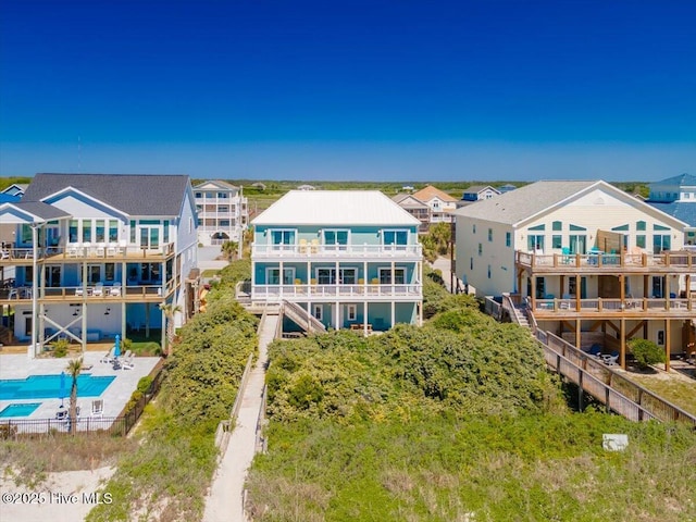 3720 Island Dr, North Topsail Beach, NC 28460 - rear view of property featuring a pool with connected hot tub and a balcony