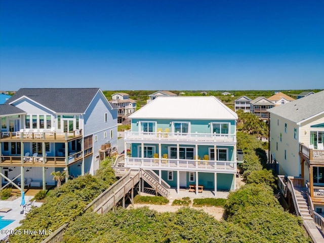 3720 Island Dr, North Topsail Beach, NC 28460 - back of property with stairway, a residential view, and a balcony