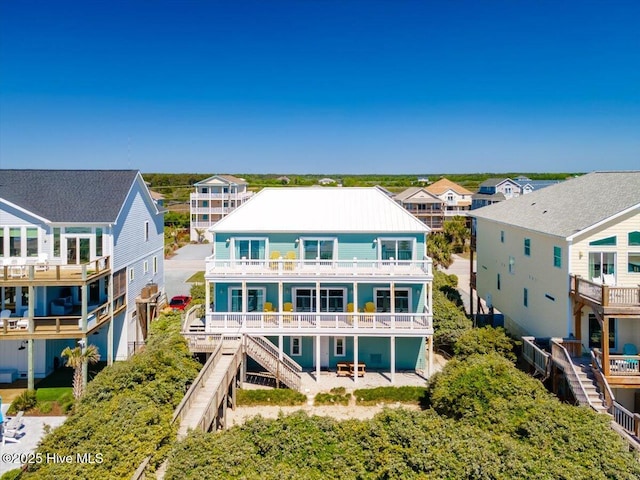 3720 Island Dr, North Topsail Beach, NC 28460 - rear view of house featuring a residential view, stairway, and a balcony