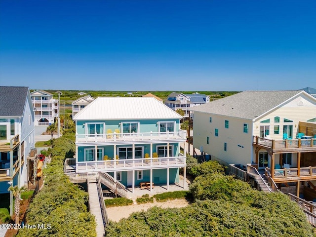 3720 Island Dr, North Topsail Beach, NC 28460 - rear view of house with a residential view, a balcony, stairway, and metal roof