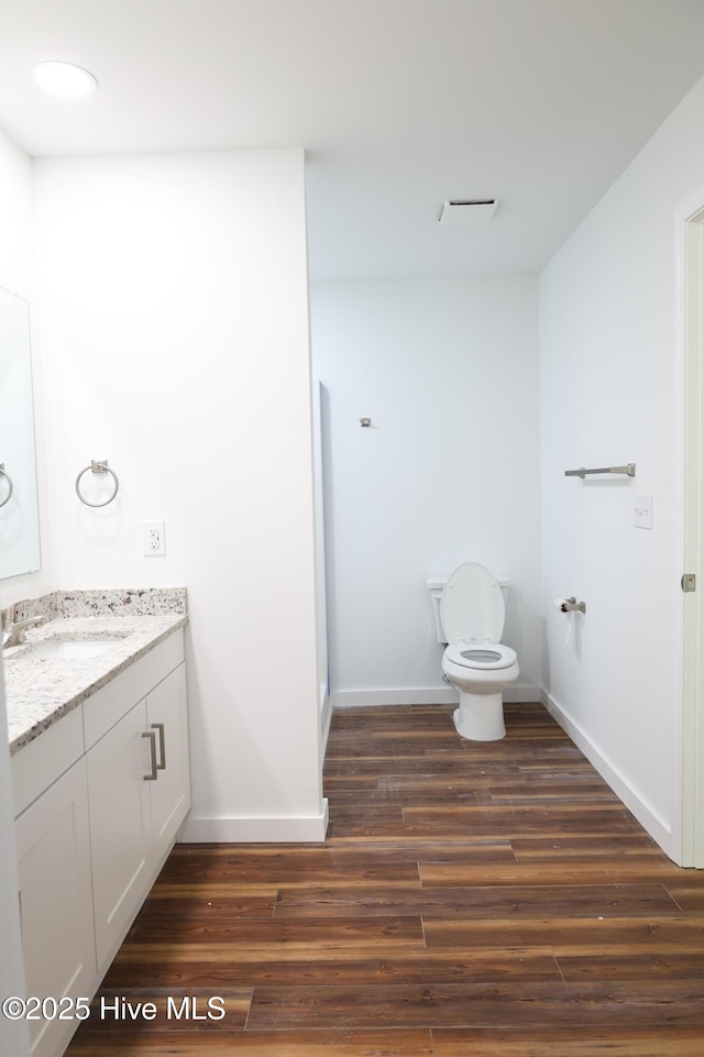 229 Spring Dr, Jacksonville, NC 28540 - full bathroom featuring vanity, toilet, wood finished floors, and baseboards
