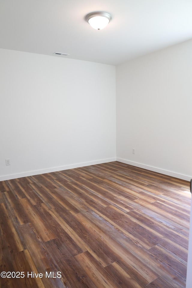 229 Spring Dr, Jacksonville, NC 28540 - unfurnished room with dark wood-style flooring and baseboards