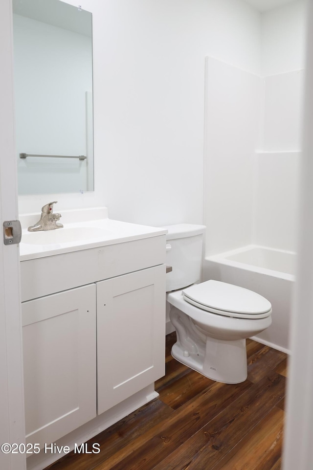 229 Spring Dr, Jacksonville, NC 28540 - bathroom featuring toilet, vanity, wood finished floors, and shower / bathtub combination