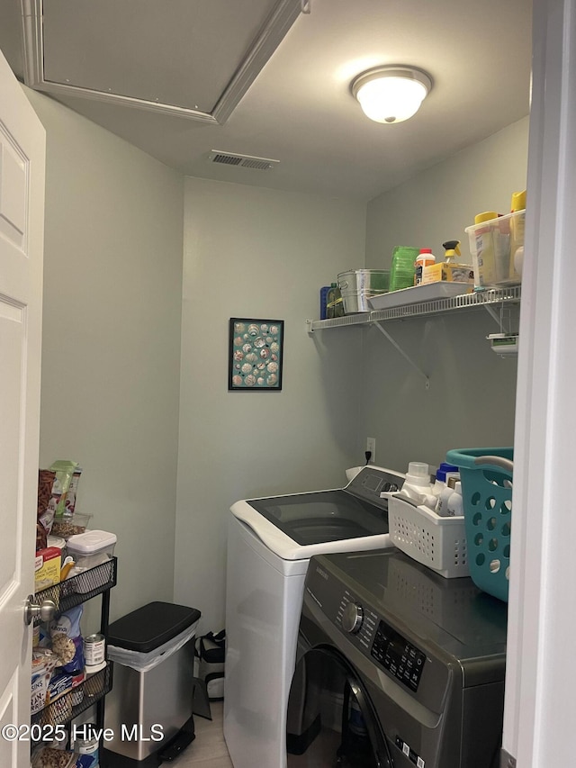 washroom featuring separate washer and dryer, laundry area, visible vents, and attic access