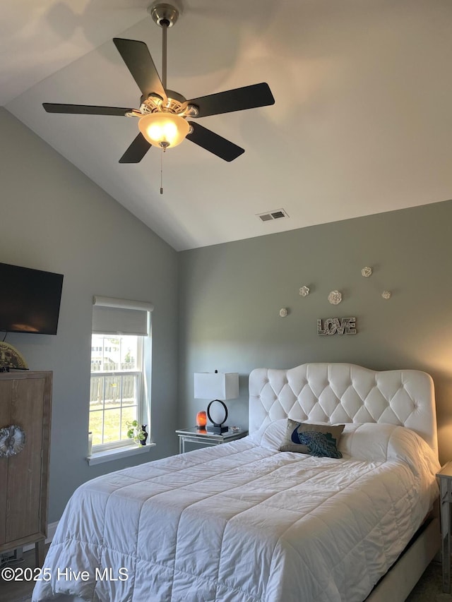 bedroom with visible vents, a ceiling fan, and lofted ceiling