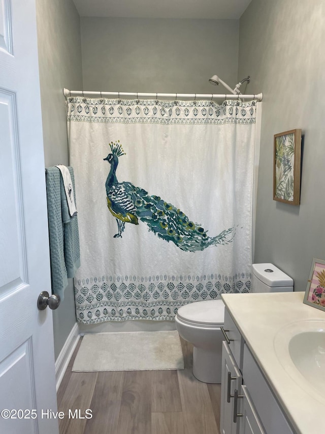 full bath with vanity, a shower with curtain, toilet, and wood finished floors