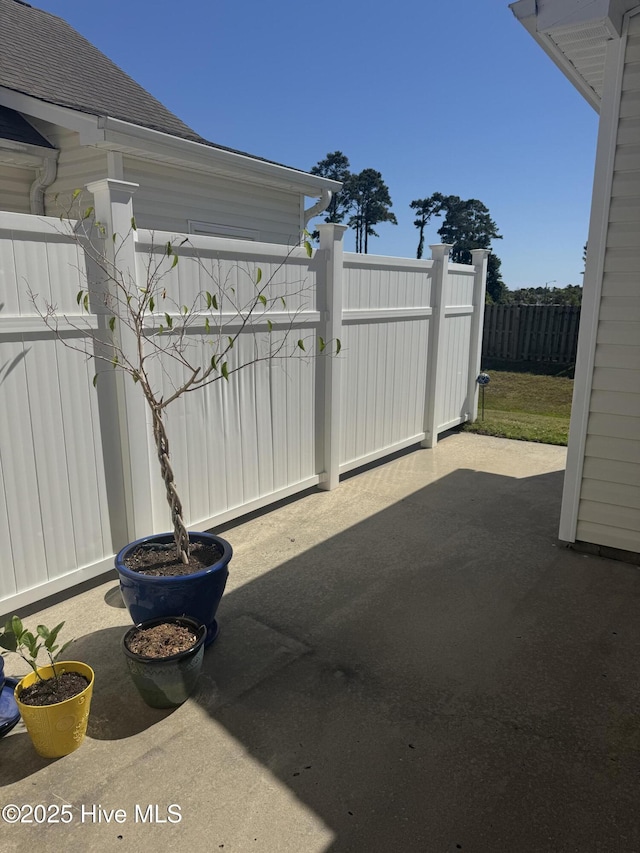 view of patio featuring fence