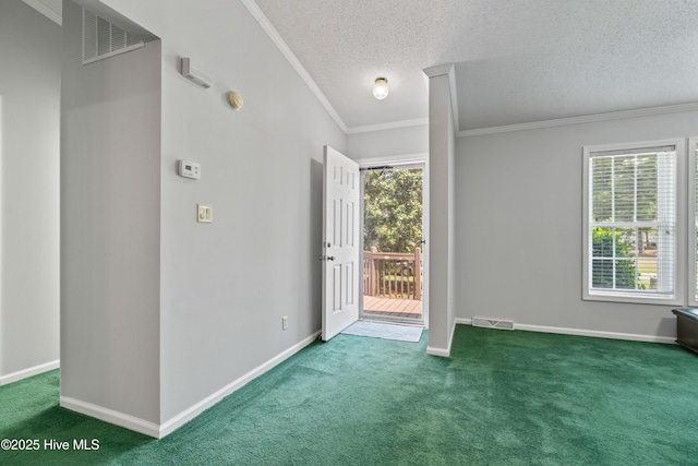 unfurnished room with visible vents, a healthy amount of sunlight, ornamental molding, and carpet floors