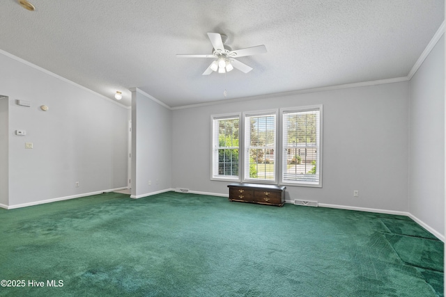 carpeted empty room featuring ornamental molding, a ceiling fan, a textured ceiling, and baseboards
