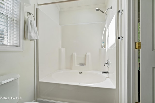 full bathroom with shower / washtub combination, toilet, and crown molding