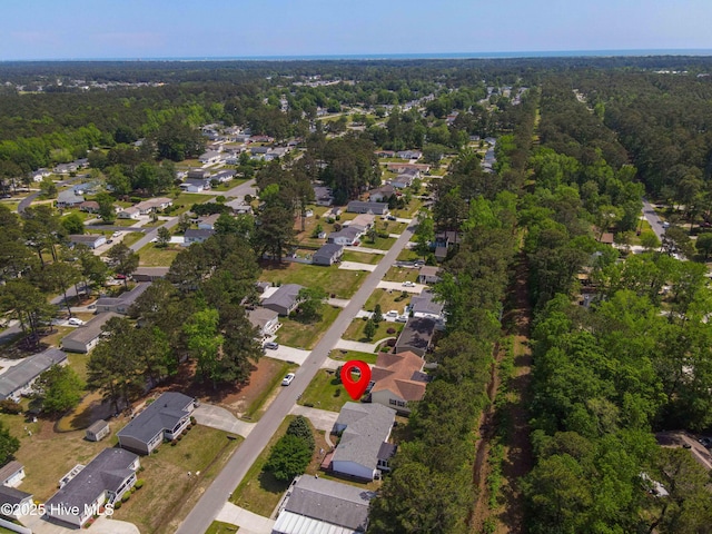 aerial view featuring a residential view and a wooded view
