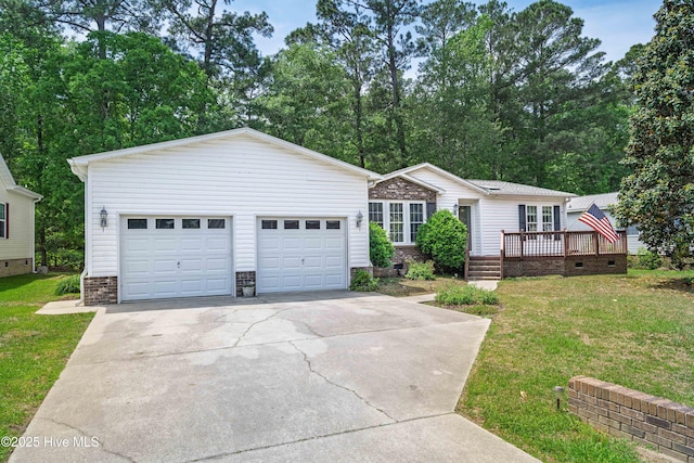ranch-style home featuring a wooden deck, a front lawn, concrete driveway, and an outdoor structure