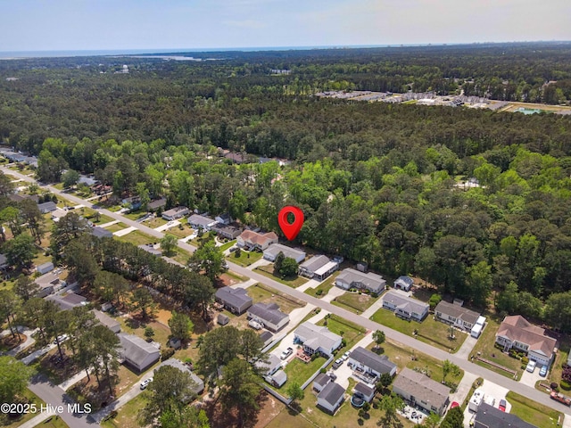 birds eye view of property featuring a wooded view and a residential view