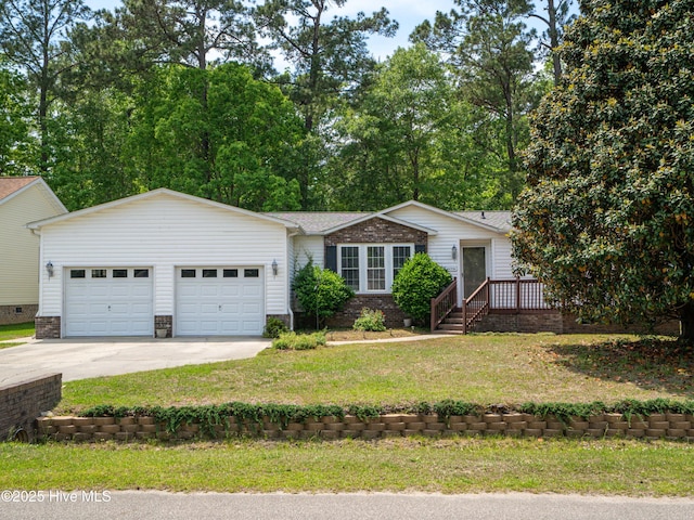 ranch-style house featuring concrete driveway, a front yard, and a garage