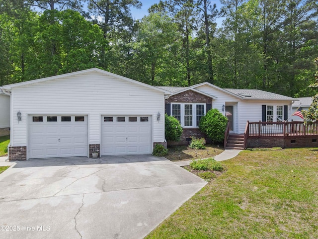 ranch-style home with concrete driveway, a deck, a front yard, an attached garage, and brick siding