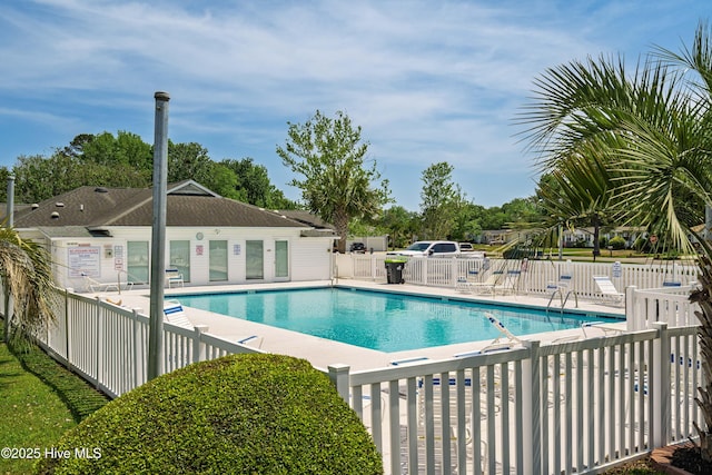 community pool with fence and a patio area