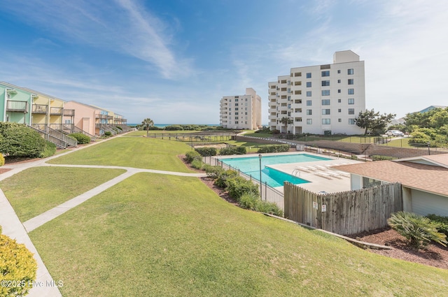pool with fence and a yard