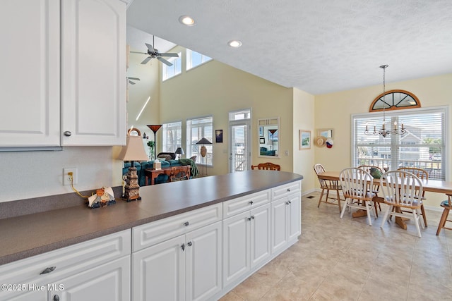 48 Wilmington St, Ocean Isle Beach, NC 28469 - kitchen with dark countertops, a peninsula, ceiling fan, white cabinetry, and recessed lighting