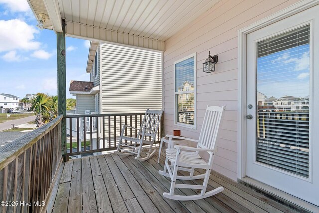 48 Wilmington St, Ocean Isle Beach, NC 28469 - wooden terrace with a residential view