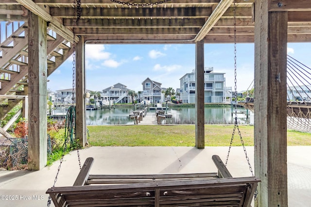 48 Wilmington St, Ocean Isle Beach, NC 28469 - view of patio / terrace featuring a water view, a dock, a residential view, and boat lift