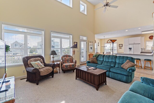 48 Wilmington St, Ocean Isle Beach, NC 28469 - living area with light colored carpet, a ceiling fan, and a high ceiling