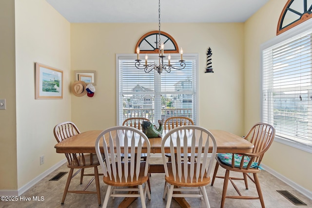 48 Wilmington St, Ocean Isle Beach, NC 28469 - dining room featuring a chandelier, healthy amount of natural light, and light tile patterned floors