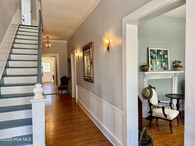 hallway featuring crown molding, stairs, and wood finished floors