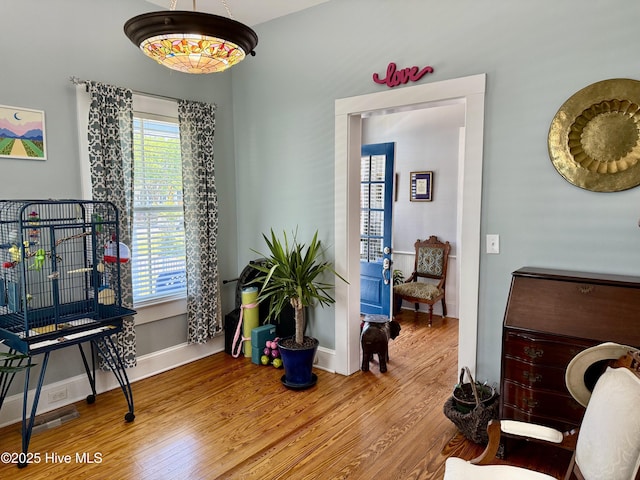 interior space with baseboards and wood finished floors