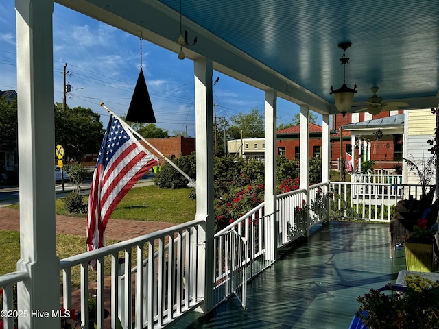 wooden deck featuring a porch and ceiling fan