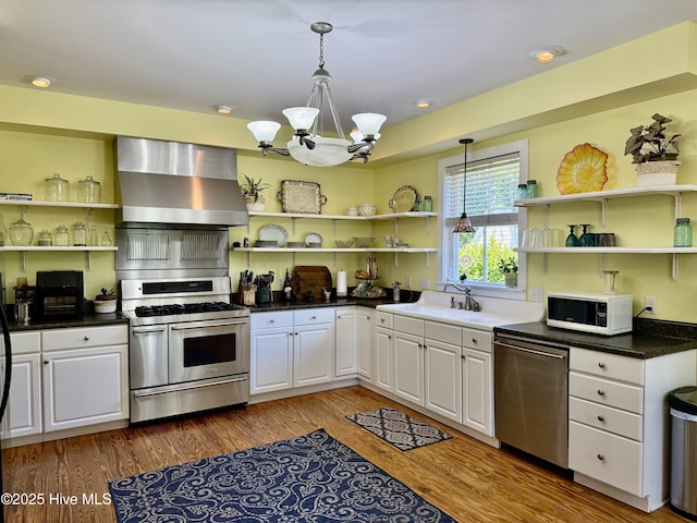 kitchen with open shelves, stainless steel appliances, wall chimney exhaust hood, and white cabinetry