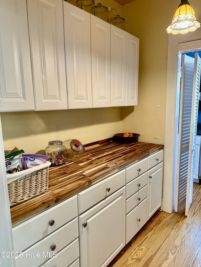 kitchen featuring light wood-style floors, white cabinetry, and butcher block counters