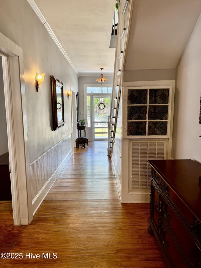corridor featuring crown molding and wood finished floors