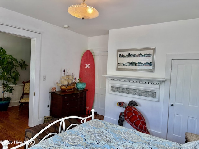 bedroom featuring baseboards and wood finished floors