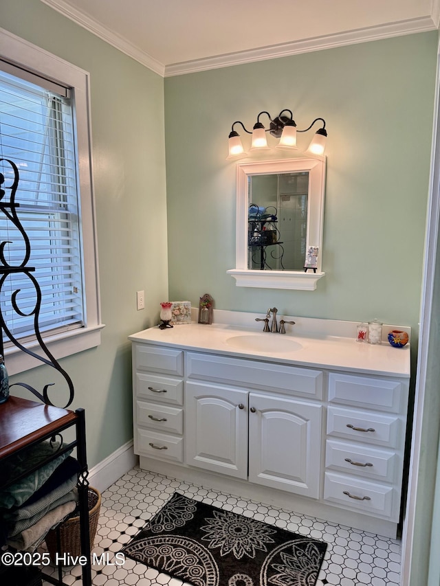 bathroom with vanity, ornamental molding, baseboards, and tile patterned floors