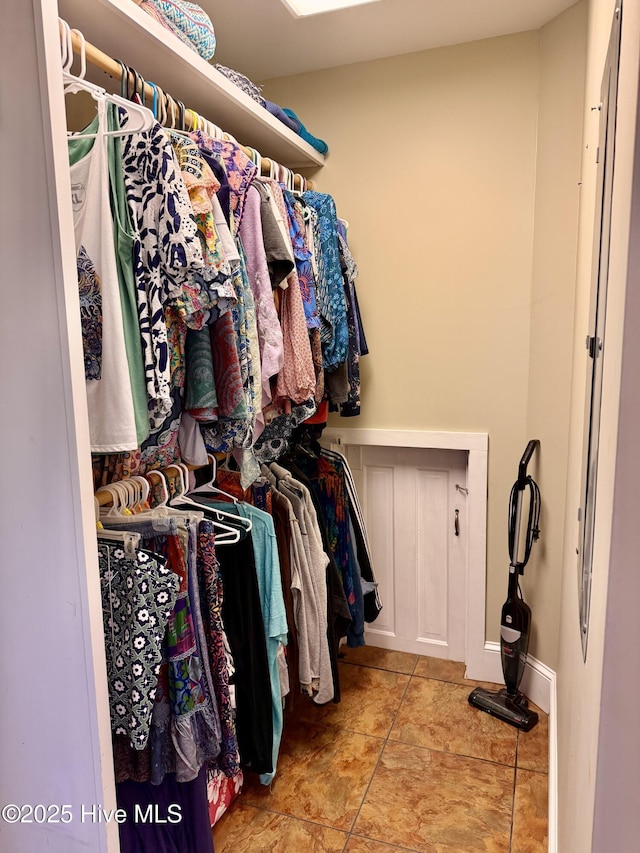 walk in closet with tile patterned flooring