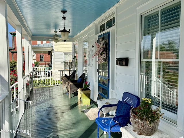 deck featuring a porch and ceiling fan