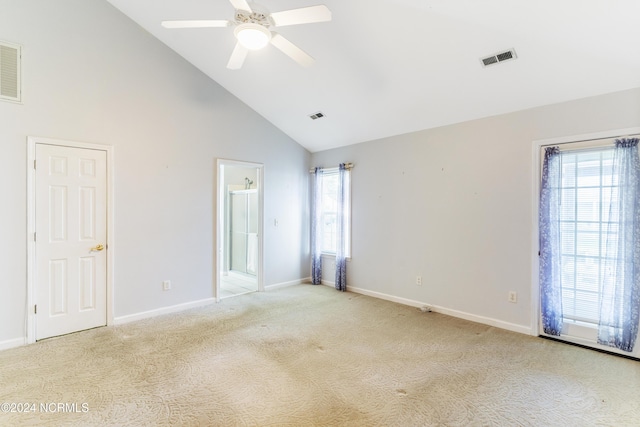 unfurnished bedroom with high vaulted ceiling, baseboards, light carpet, and visible vents